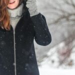 woman standing while holding her jacket