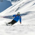 man snow skiing on bed of snow during winter